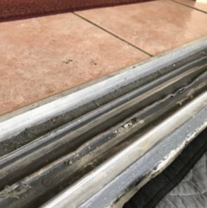 Debris in sliding door track causing door to stick in Lutz, FL